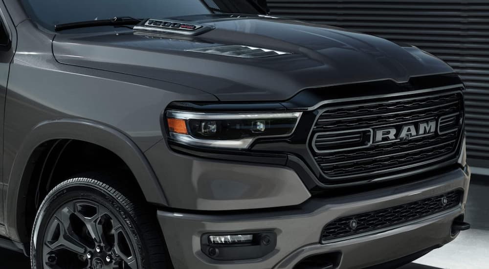 A close up shows the grille of a grey 2021 Ram 1500.