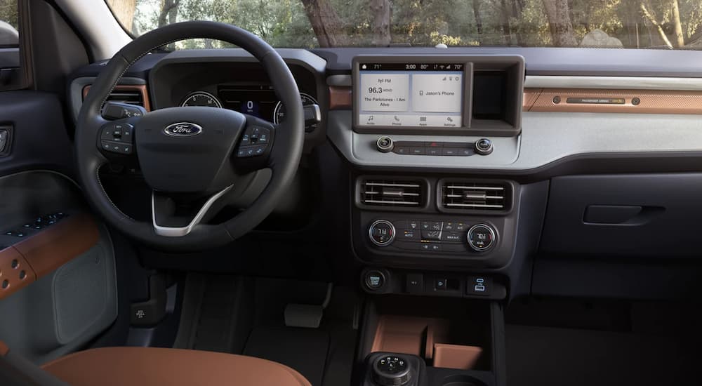 The interior of a 2022 Ford Maverick shows the steering wheel and infotainment screen.