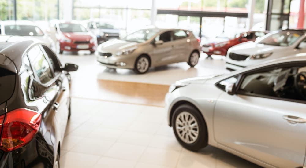The inside of a car dealership is shown.