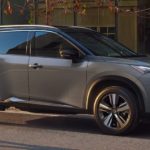 A grey 2021 Nissan Rouge is shown driving to a Nissan dealer near you.