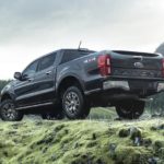 A black 2021 Ford Ranger is shown from the rear parked in the mountains.
