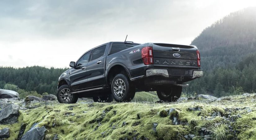 A black 2021 Ford Ranger is shown from the rear parked in the mountains.