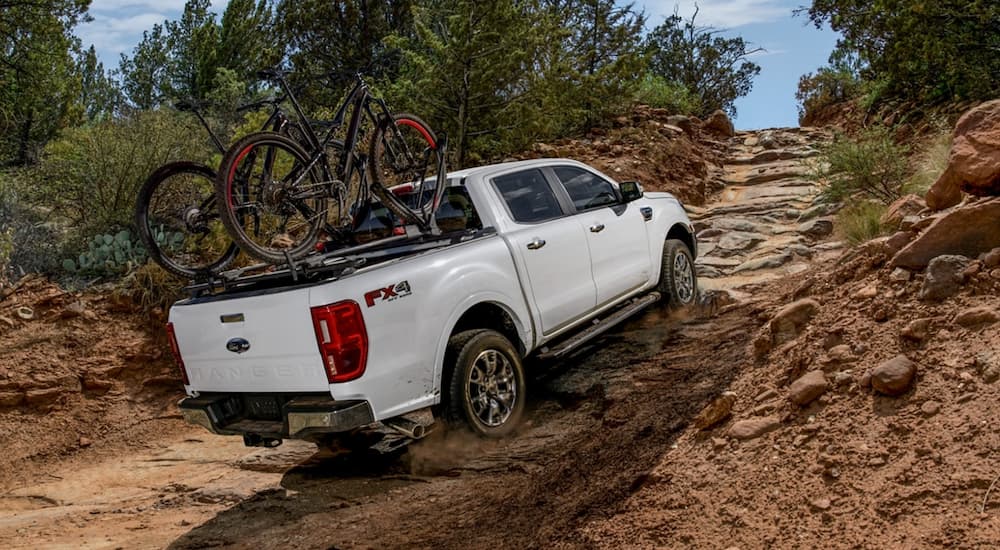A white 2021 Ford Ranger is shown off-roading after winning a 2021 Ford Ranger vs 2021 Toyota Tacoma comparison. 