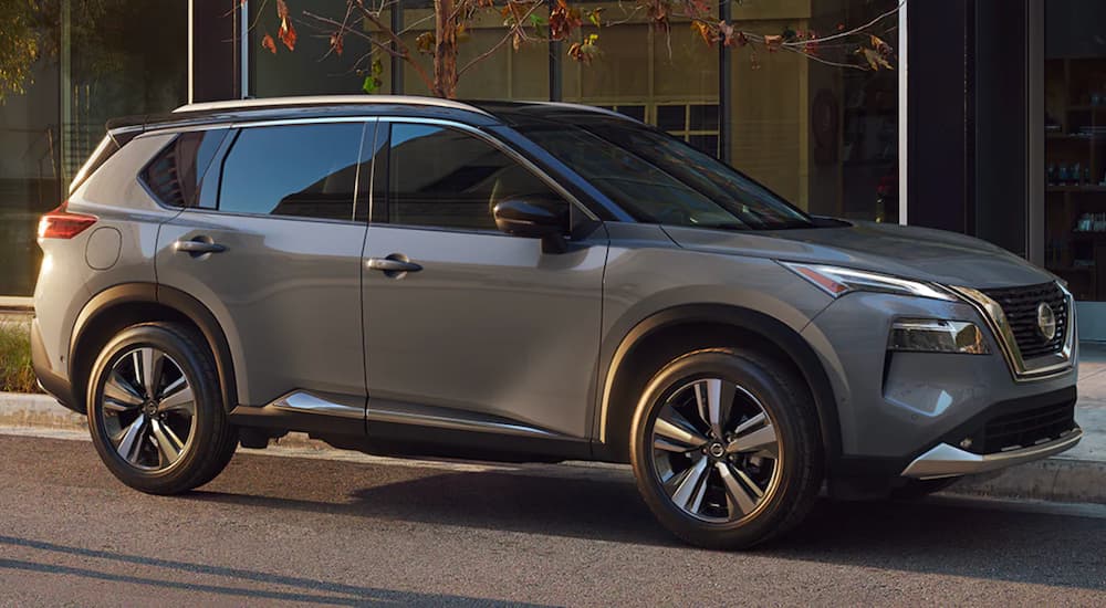 A grey 2021 Nissan Rogue is shown parked in a city.