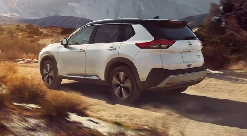 A white 2021 Nissan Rogue is shown from the rear off-roading after winning a 2021 Nissan Rogue vs 2021 Subaru Forester comparison.
