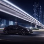 A black 2021 Toyota Corolla SE Nightshade Edition is shown driving under a bridge at night.