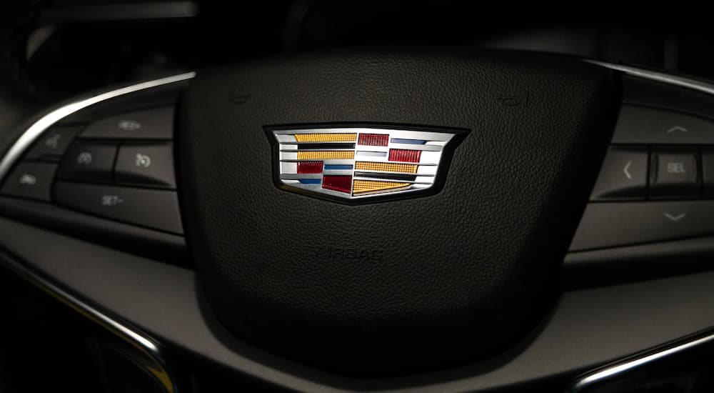 A close up shows the Cadillac emblem on the steering wheel of a 2022 Cadillac XT5.