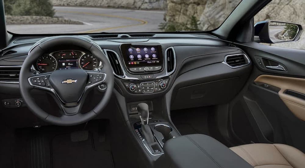 The interior of a 2022 Chevy Equinox shows the steering wheel and infotainment screen.