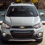 A silver 2022 Chevy Spark is shown from the front parked in a parking space.