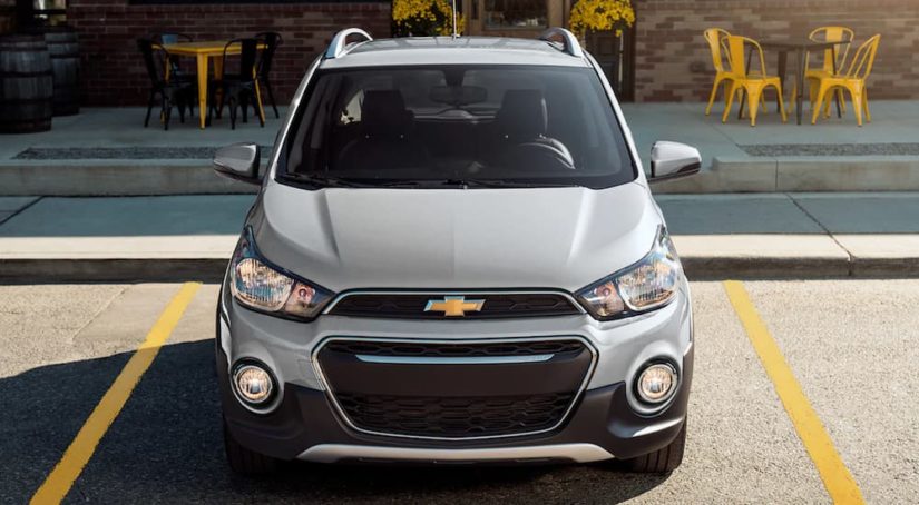 A silver 2022 Chevy Spark is shown from the front parked in a parking space.