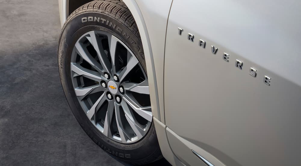 A white 2022 Chevy Traverse shows the front tire.