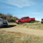 Three 2022 Ford Mavericks are parked in a field after winning a 2022 Ford Maverick vs 2021 Ford Ranger comparison.
