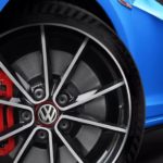 A blue 2022 Volkswagen Golf GTI is shown from a low angle.