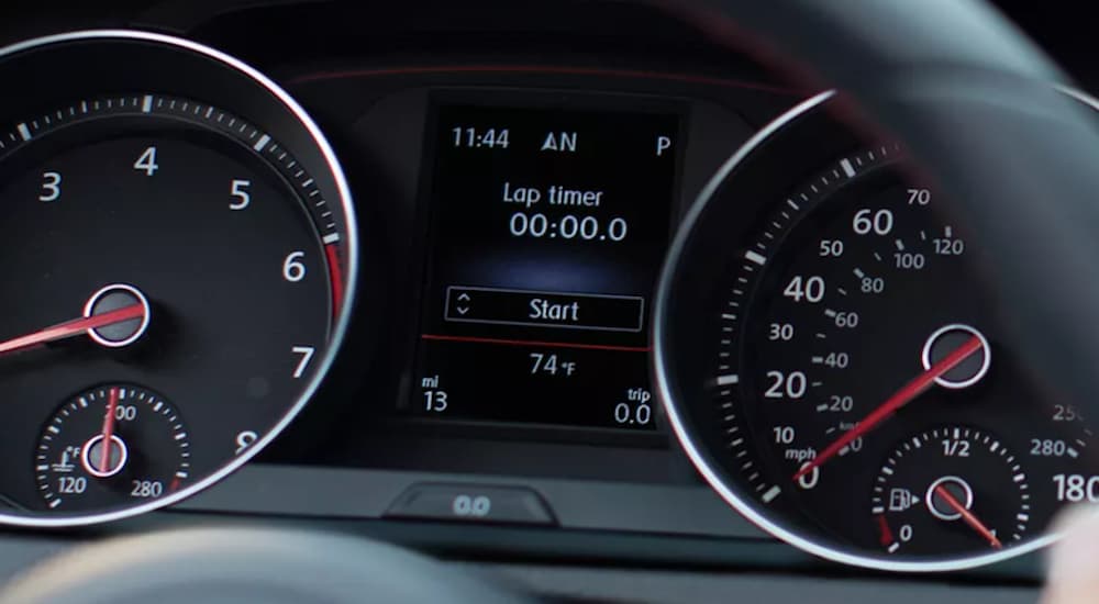 The black interior of a 2022 Volkswagen Golf R shows the gages.