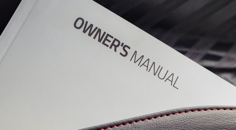 A close up shows an owners manual.