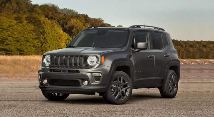 A grey 2021 Jeep Renegade is shown from the front parked in a desert.