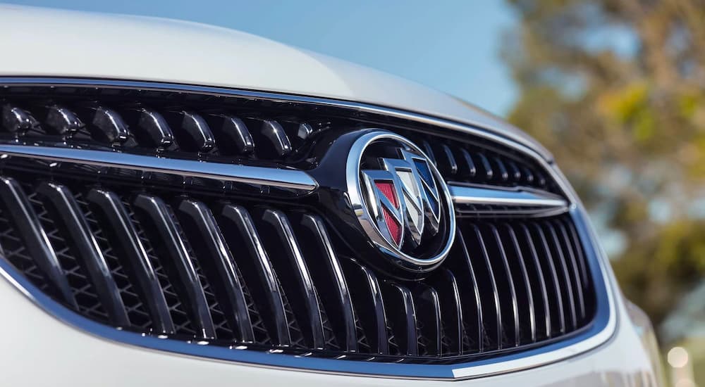 A close up shows the grille of a white 2022 Buick Encore from an angle.