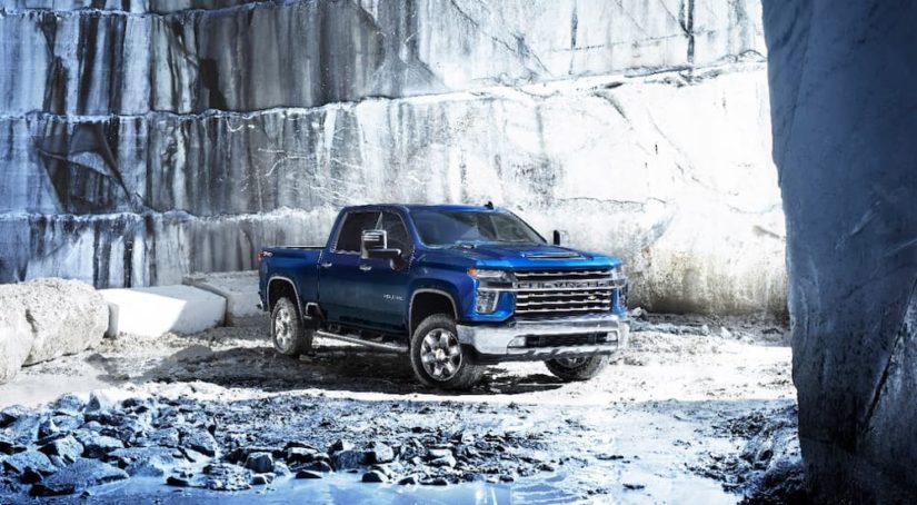 A blue 2022 Chevy Silverado 2500HD parked in a stone quarry.
