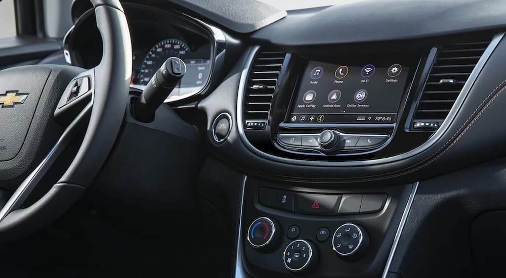 The black interior of a 2022 Chevy Trax shows the infotainment screen.