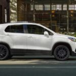 A white 2022 Chevy Trax is shown from the side parked in a city.