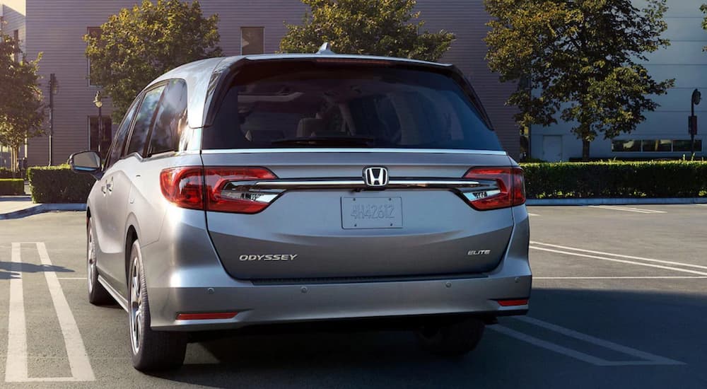 A silver 2022 Honda Odyssey is shown from the rear parked in a lot.