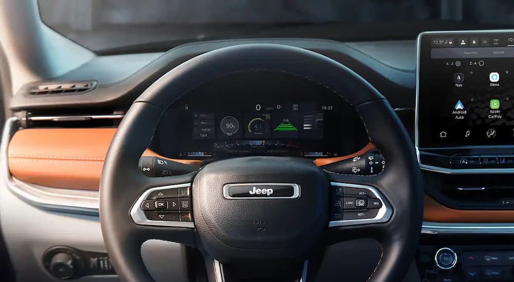 A close up shows the gauges and steering wheel of a 2022 Jeep Compass after winning the competition between 2022 Jeep Compass vs 2022 Chevy Equinox.