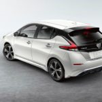 A white 2022 Nissan Leaf is shown from the rear parked on a concrete floor.