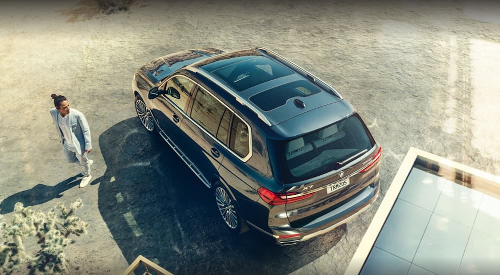 A black 2022 BMW X7 is shown from above parked in a dirt lot.
