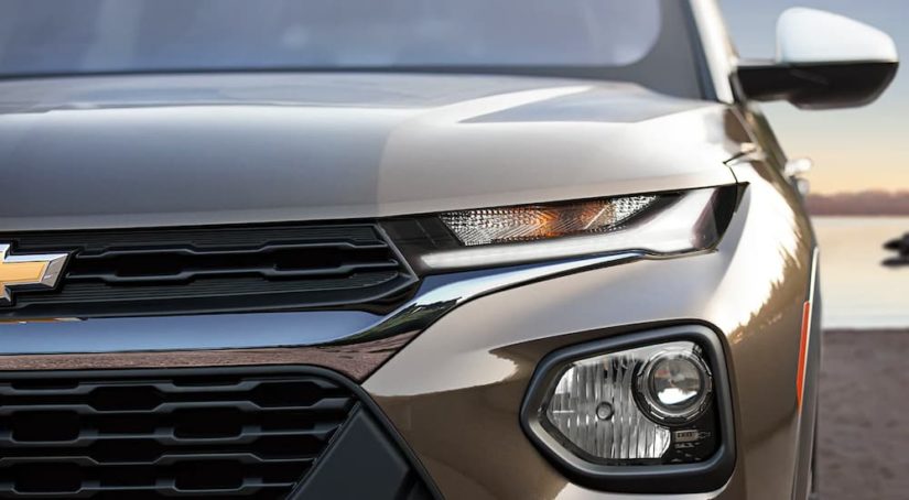 A close up shows the driver side headlight on a tan 2022 Chevy Trailblazer ACTIV.