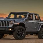 A grey 2021 Jeep Wrangler 4xe is shown from the side parked in a desert after leaving a Jeep dealership.