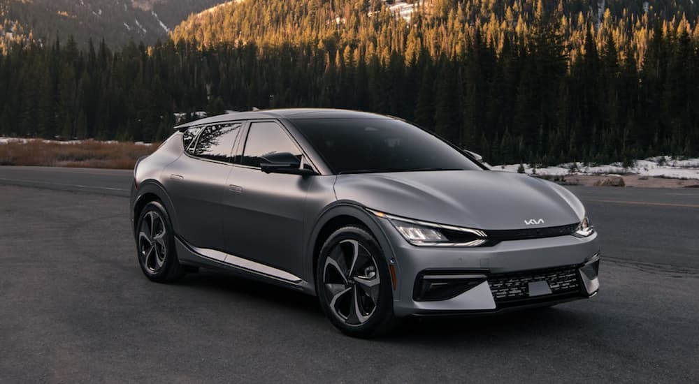 A grey 2022 Kia EV6 is shown from the side parked in front of a mountain.