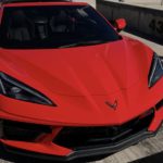 A red 2022 Chevy Corvette is shown from the front parked on a cement structure.