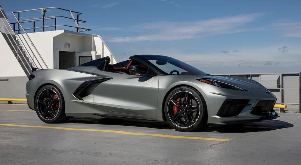 A silver 2022 Chevy Corvette is shown from the side parked on a cement structure.