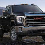 A black 2022 GMC Sierra 2500HD Pro is shown towing an ATV on a trailer.