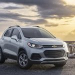 A silver 2022 Chevy Trax is shown from the front parked in front of a jetty.