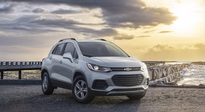 A silver 2022 Chevy Trax is shown from the front parked in front of a jetty.