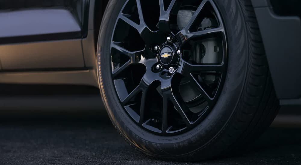 The black wheel and tire on a 2022 Chevy Trax is shown in close up.