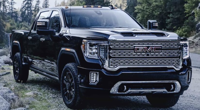 A black 2022 GMC Sierra 2500 HD is shown from the front parked in the mountains.