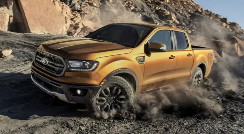 A yellow 2022 Ford Ranger is shown from the side after leaving a Ford Pre-Order dealer.