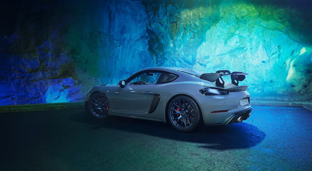A grey 2022 Porsche 718 Cayman GT4 RS is shown parked from a rear angle.