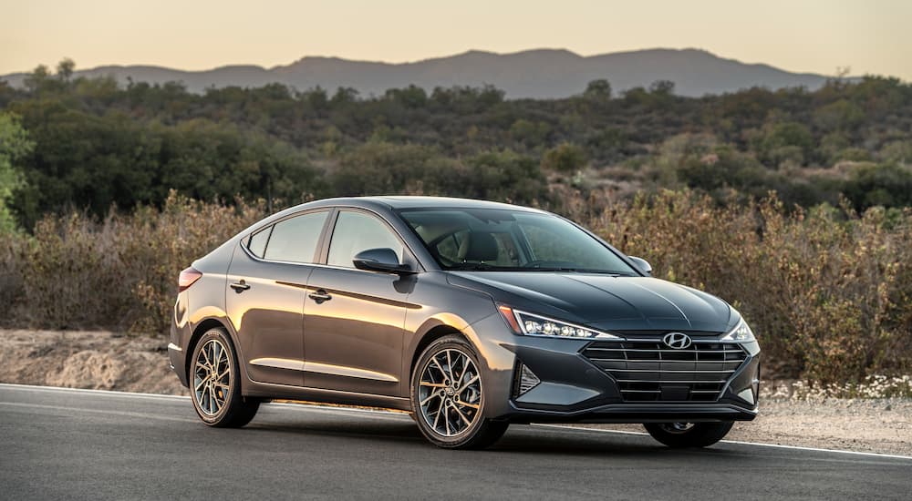 A black 2019 Hyundai Elantra SEL is shown parked on the side of a highway.
