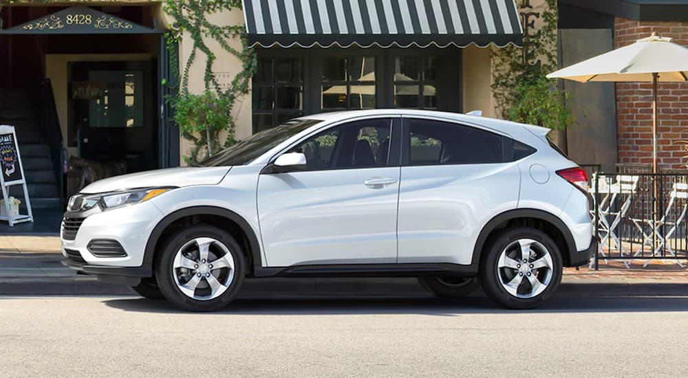 A white 2020 Honda HR-V is shown parked on the side of a city street.