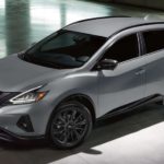 A grey 2021 Nissan Murano is shown from the side parked in a modern gallery after winning a 2021 Nissan Murano vs 2021 Ford Edge comparison.