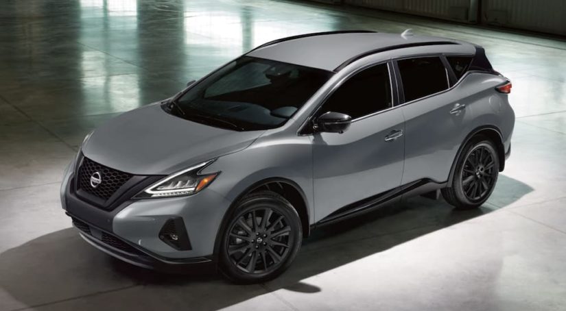 A grey 2021 Nissan Murano is shown from the side parked in a modern gallery after winning a 2021 Nissan Murano vs 2021 Ford Edge comparison.