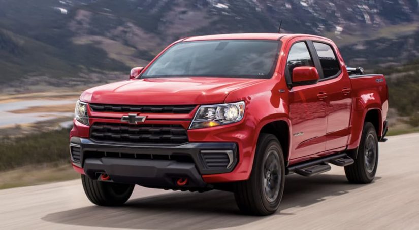 A red 2022 Chevy Colorado is shown from the front driving on an open road.
