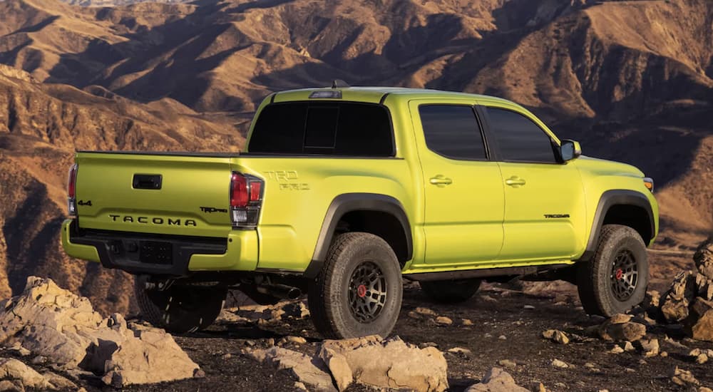 A green 2022 Toyota Tacoma TRD Pro Double Cab is shown from the side parked in the mountains.