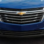 A close up shows the grille and headlights of a blue 2022 Chevy Equinox LT.