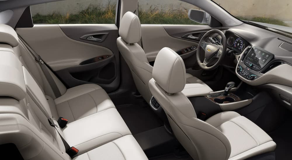 The white interior of a 2022 Chevy Malibu shows two rows of seating.
