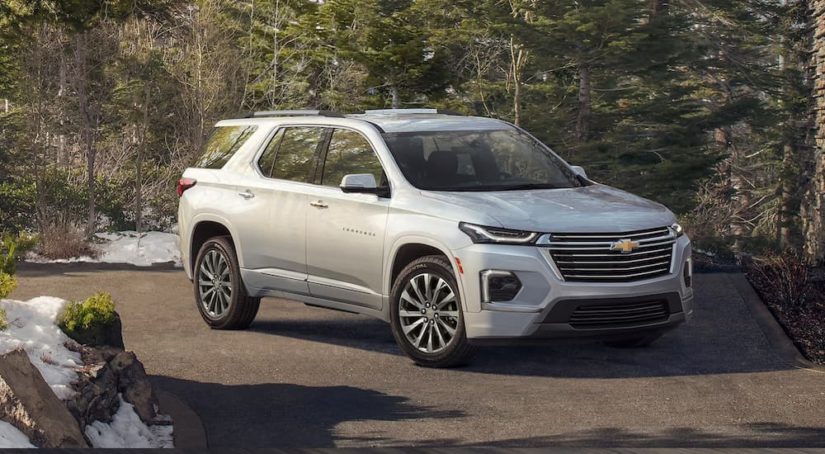 A silver 2022 Chevy Traverse Premier is shown parked in a driveway.