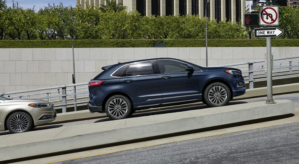 A 2022 Ford Edge Titanium Elite is shown from the side on a city street.